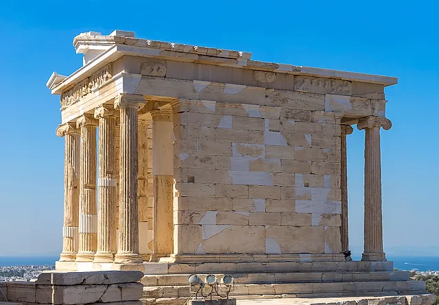 The small Ionic Temple of Athena Nike on its bastion under a blue sky